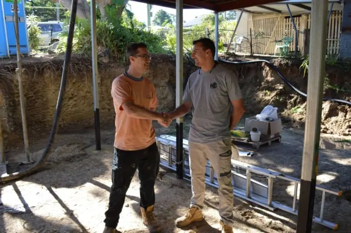 Manttan Construction builder shaking hands with a client on a Brisbane site
