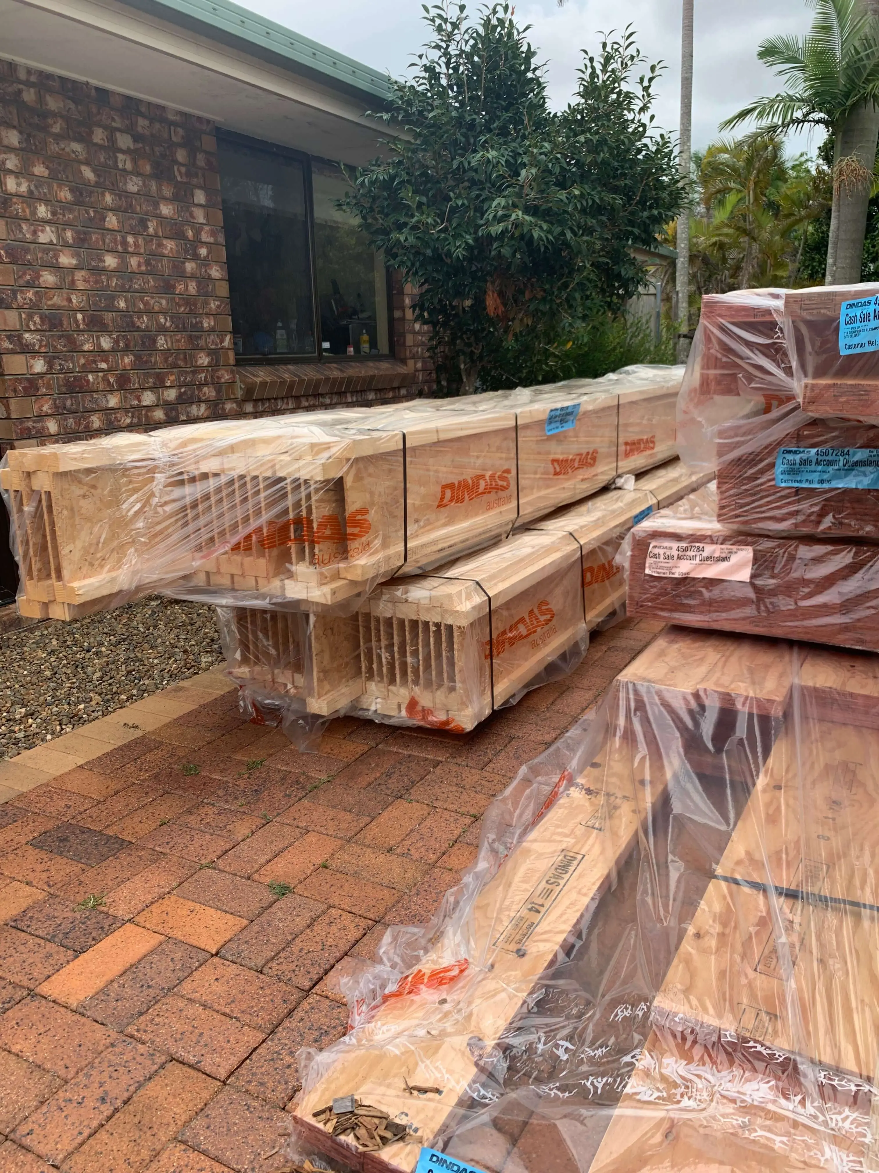 Dindas LVL and framing timber delivery stacked on a Redlands driveway