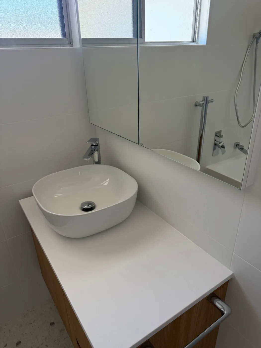Timber vanity with vessel basin and mirror in a Brisbane bathroom renovation