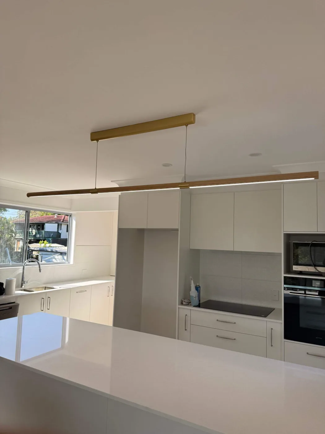White cabinetry and stone benchtops in a completed Brisbane kitchen renovation