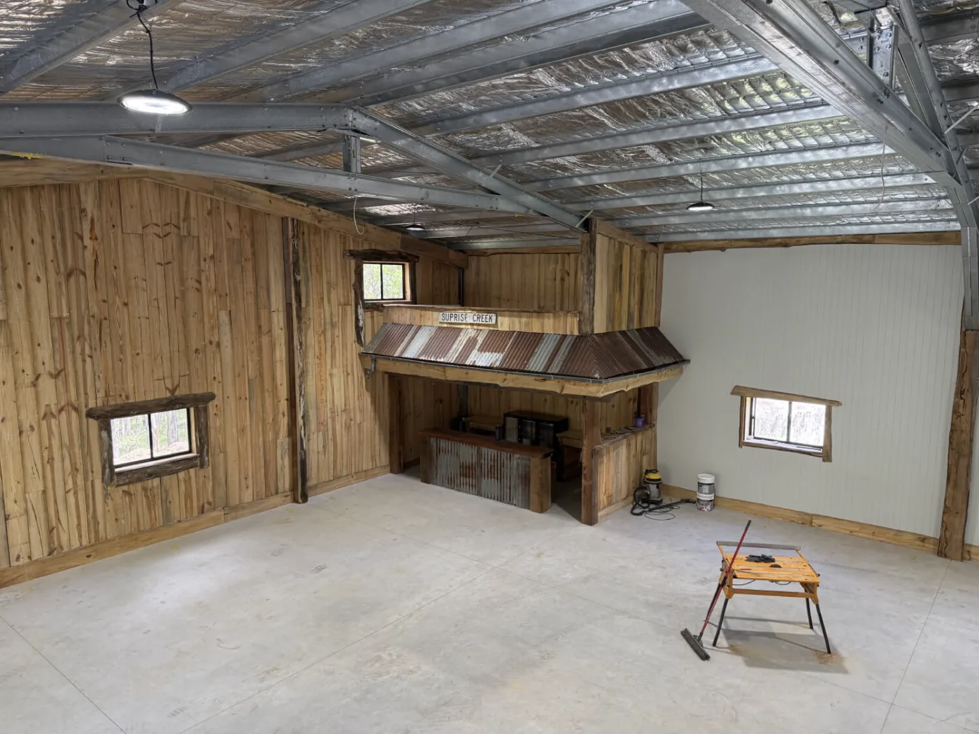 Timber-lined man cave interior with the finished bar under the mezzanine