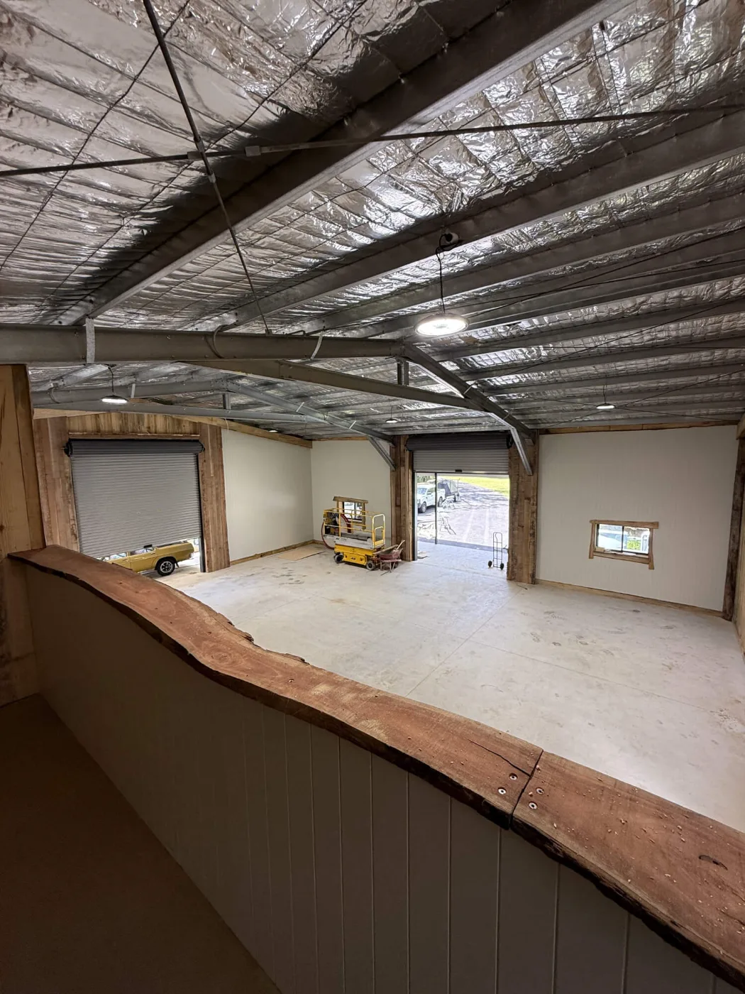 View from the man cave bar across the workshop bays and roller doors