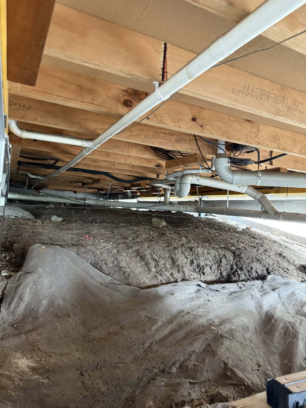 Subfloor services and framing exposed under a Brisbane home during structural work
